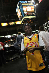 JAJF young boy at pro basketball game treating the families not the cancer 