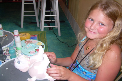 JAJF young girl painting a porcelain doll enjoying a break from late stage cancer 