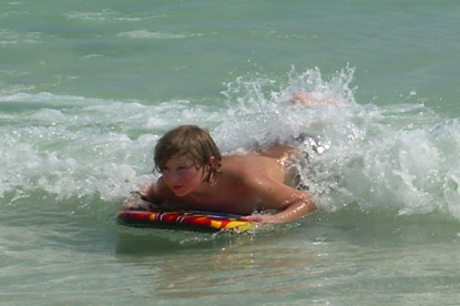 young boy boogie boarding in the ocean on a Jack and Jill Foundation trip 