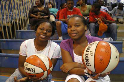 JAJF siblings at basketball game holding basketballs 