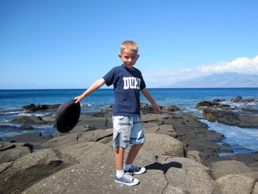 young JAJF boy posing on rocks by the water 