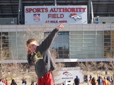 young boy at Sports Authority Field taking a cancer timeout 