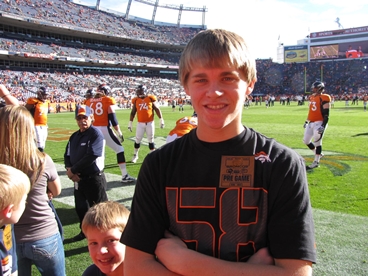 young man at football field taking late stage cancer timeout 