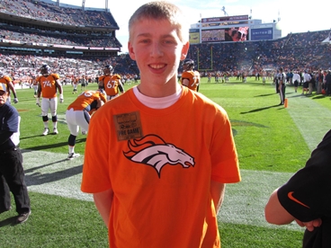 young man at Denver Bronco's football game taking a cancer timeout 