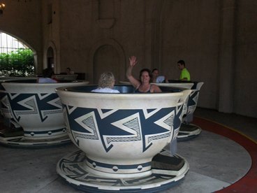 family in teacup ride at theme park enjoying a late stage cancer timeout 