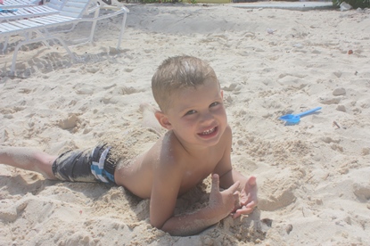 Jack and Jill Foundation young boy playing in the sand at the beach 