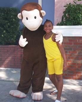 JAJF girl with Curious George character at theme park 