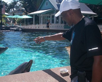 Jack and Jill Foundation man feeding dolphins 