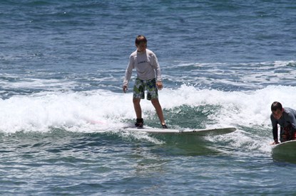 Jack and Jill Foundation boy on surfboard in ocean enjoying a timeout from late stage cancer 
