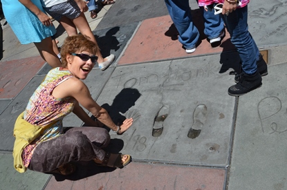 woman at Tom Hanks' handprints on Hollywood Walk of Fame 