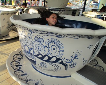 young girl in teacup ride taking a timeout from late stage cancer 