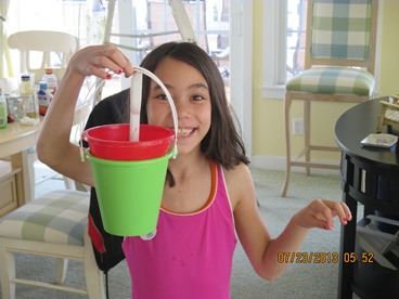 young girl with sand bucket taking a timeout from late stage cancer 