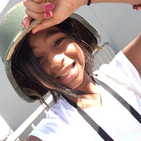young girl in soldier's helmet 