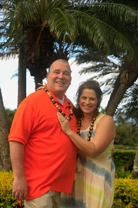 couple with leis on tropical vacation 