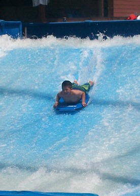 young boy in swimming pool tube 