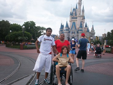 family at Disney World castle making lasting memories with JAJF 
