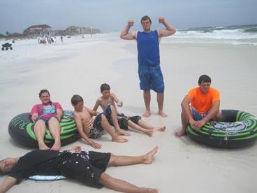 family on the beach with inflatable tubes enjoying a JAJF break 