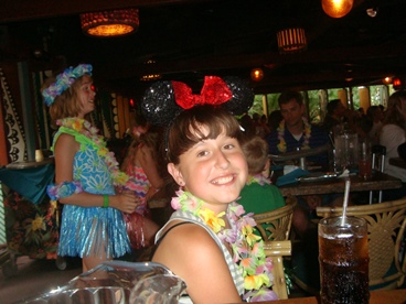 young girl with Minnie mouse ears and lei making inheritable memories 