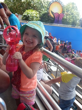 young girl playing with portable fan during JAJF trip 