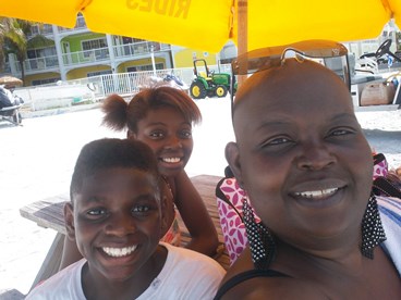 JAJF family on beach with yellow umbrella making inheritable memories 
