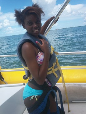 teenage girl on boat ready to parasail during JAJF break 