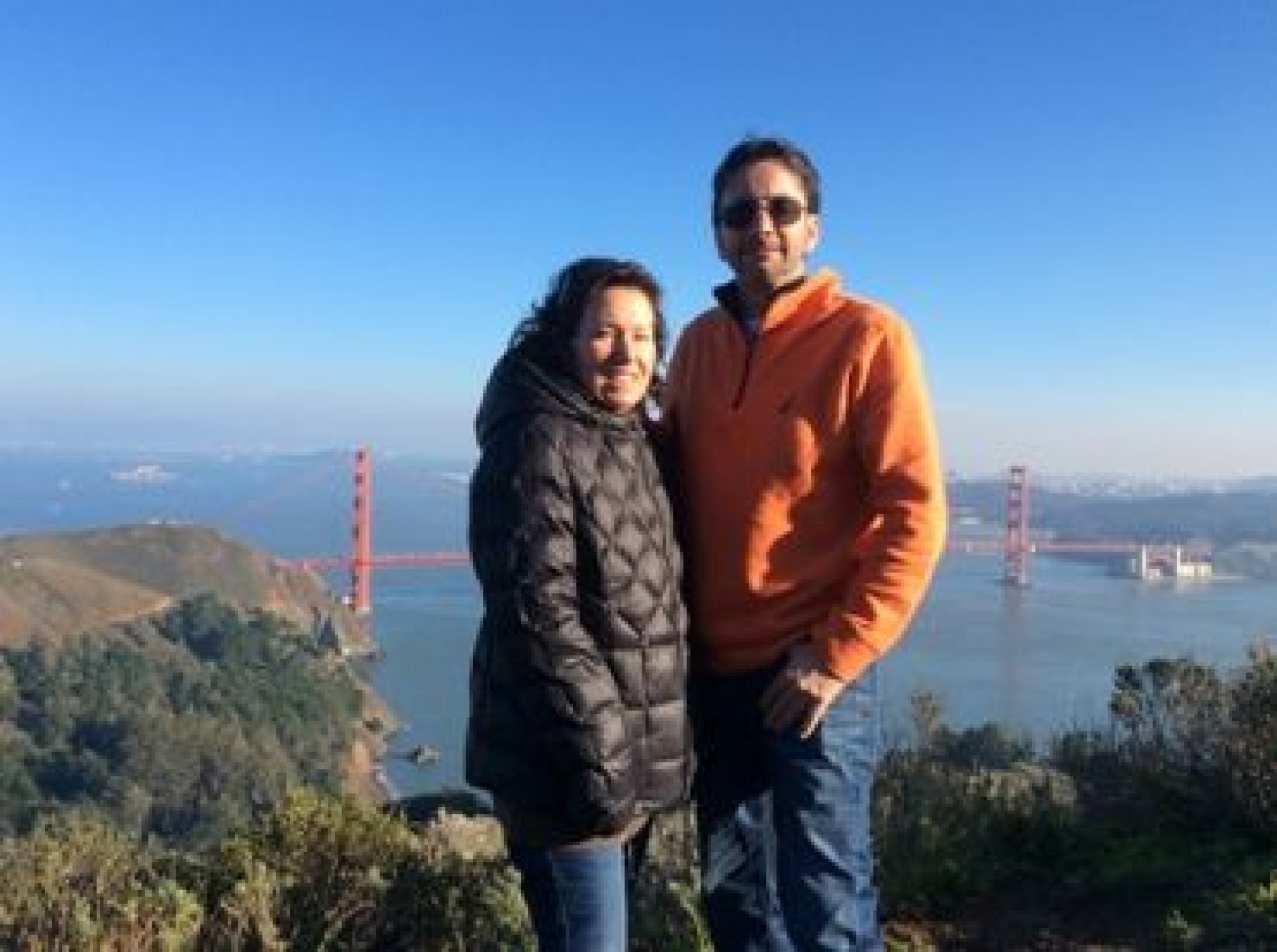 couple standing in front of Golden Gate bridge enjoying a JAJF WOW experience 