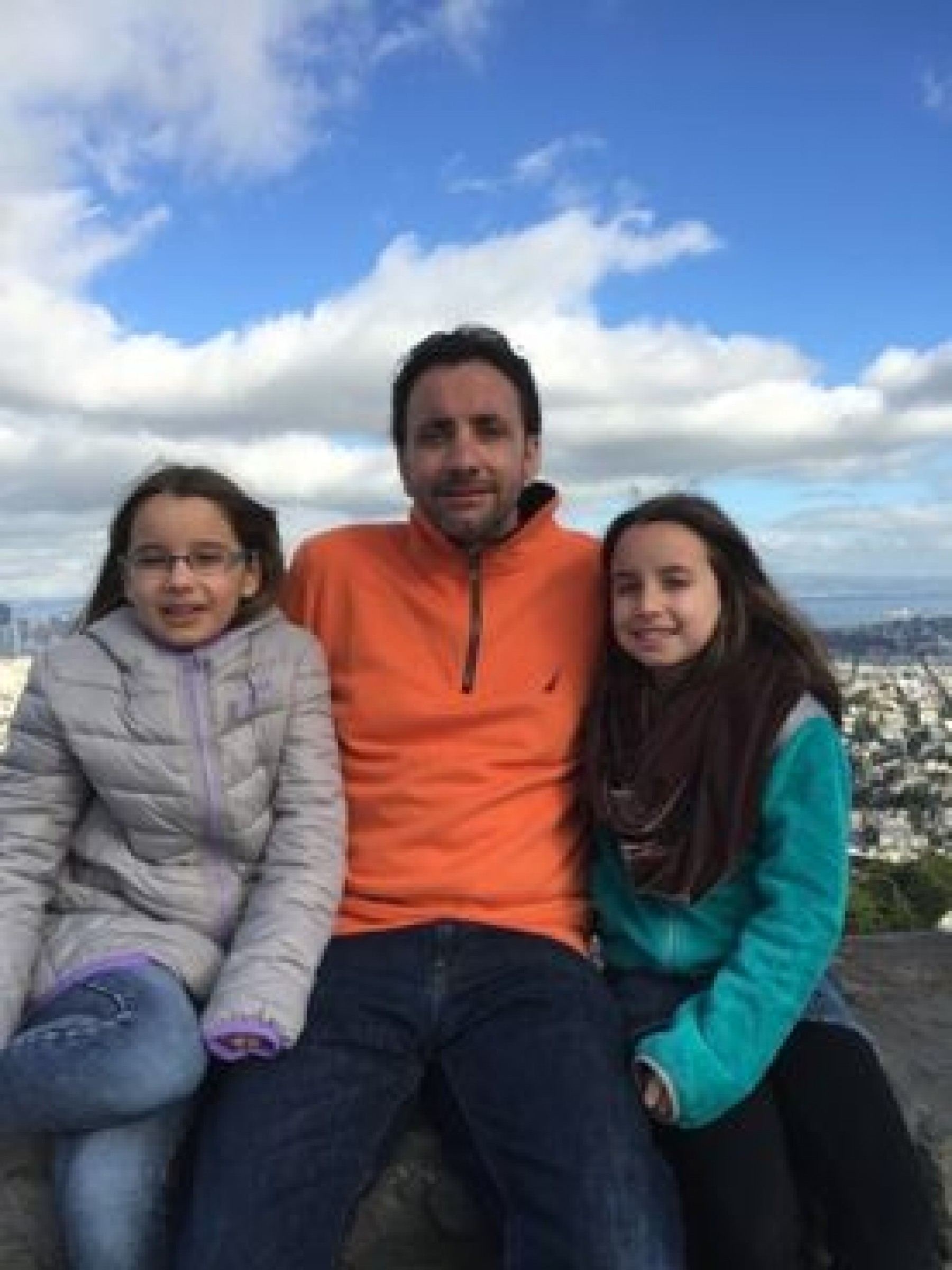dad and daughters overlooking city during a JAJF WOW experience 