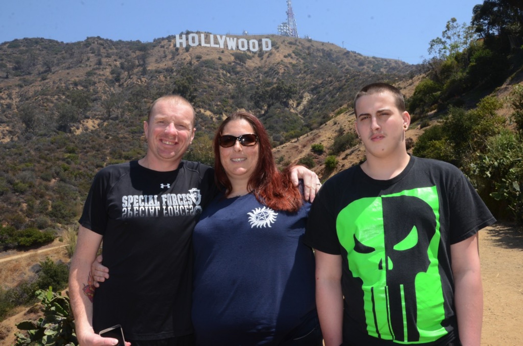 family posing at Hollywood sign during JAJF WOW experience 