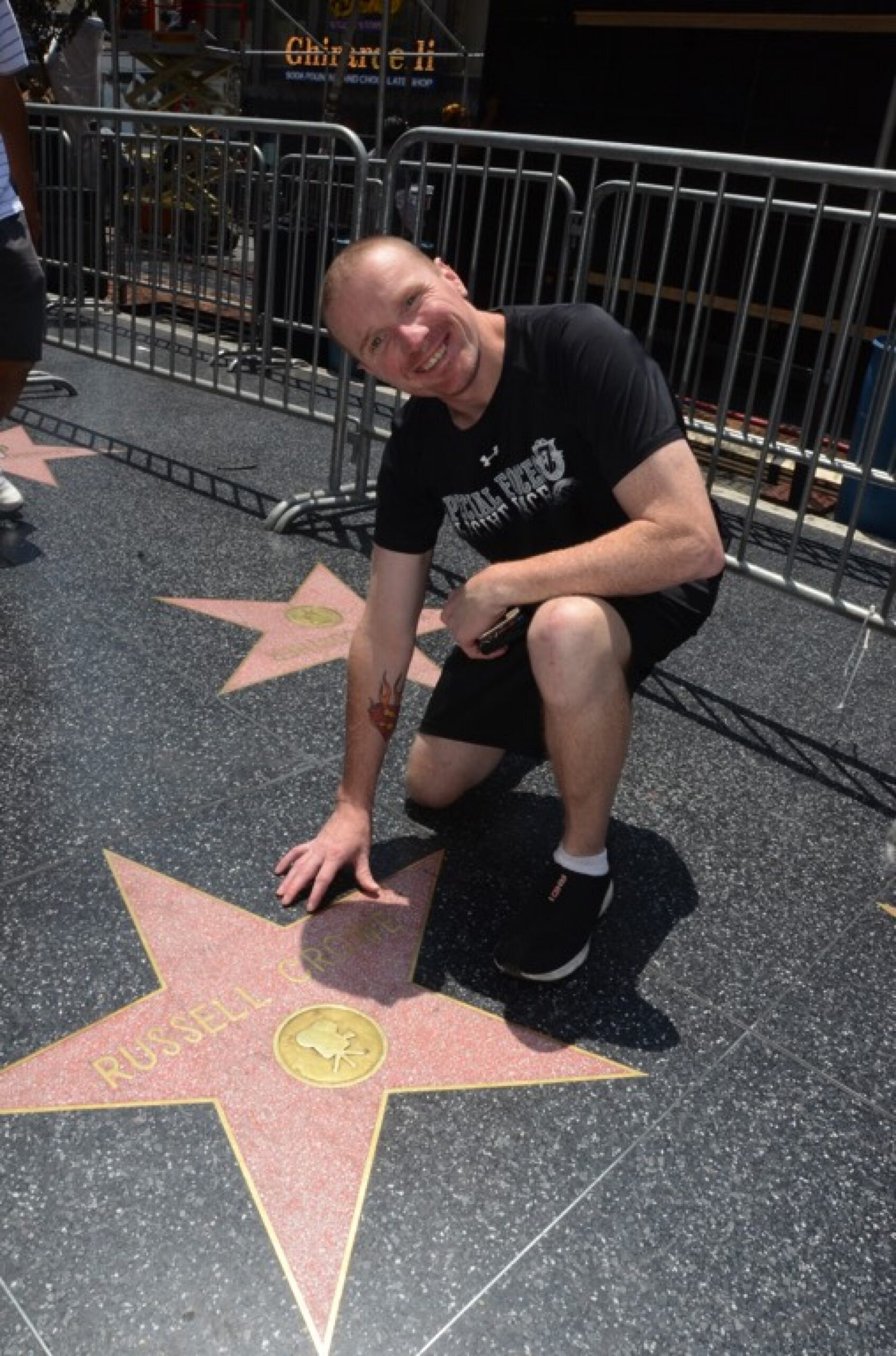 man posing with star on Hollywood Walk of Fame during JAJF WOW experience 