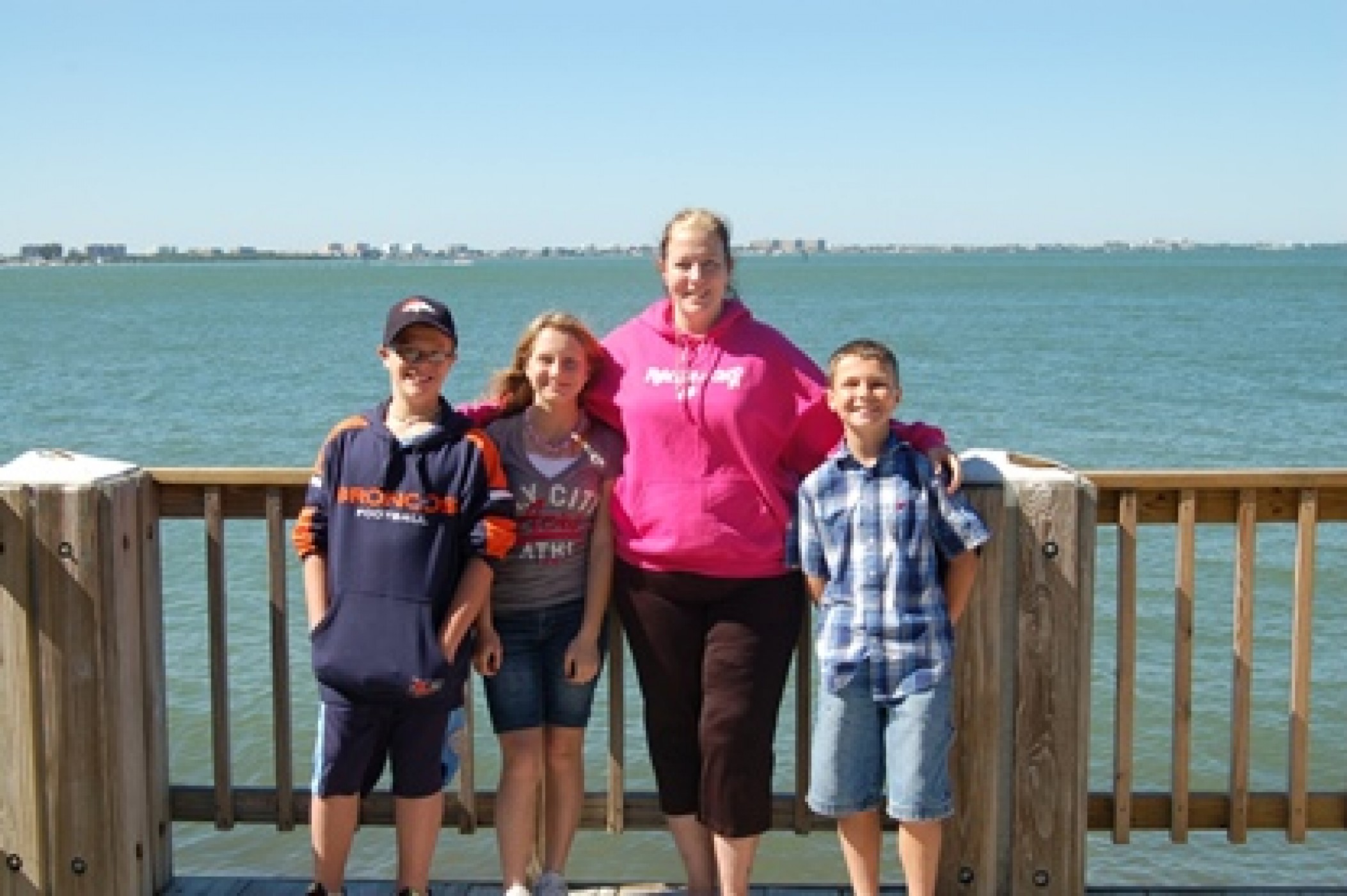 mom and children posing on boardwalk overlooking water during JAJF WOW experience 