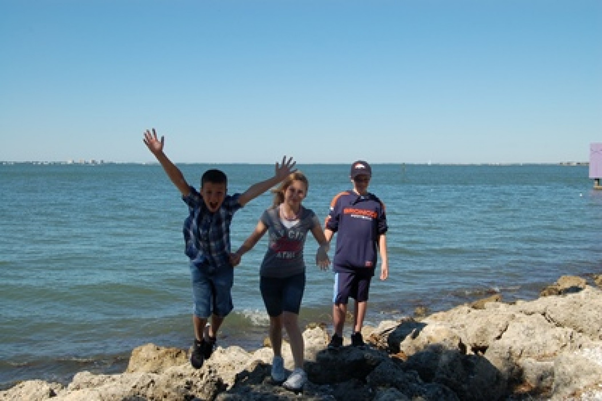 siblings on rocks overlooking water during JAJF WOW experience 