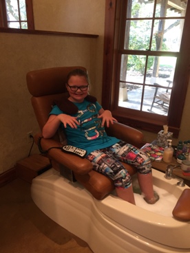 young girl getting a manicure and pedicure during a JAJF WOW experience 