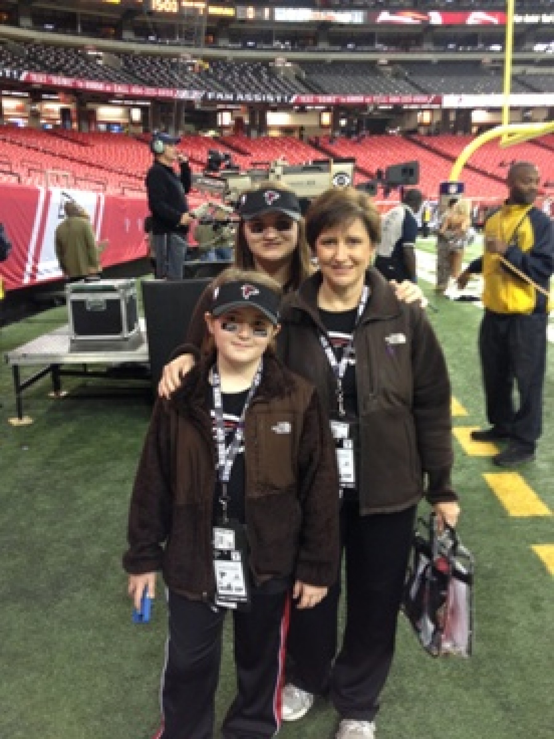 family on the field during Atlanta Falcons football game during a WOW experience 