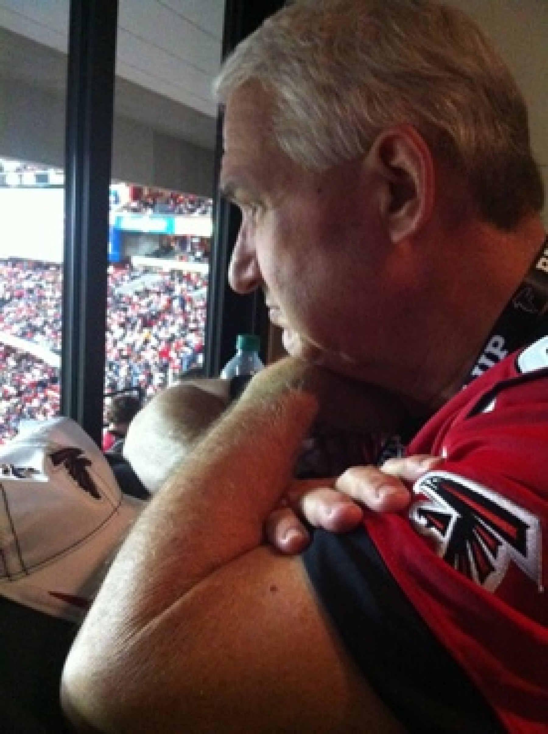 man watching Atlanta Falcons football game during a JAJF WOW experience 