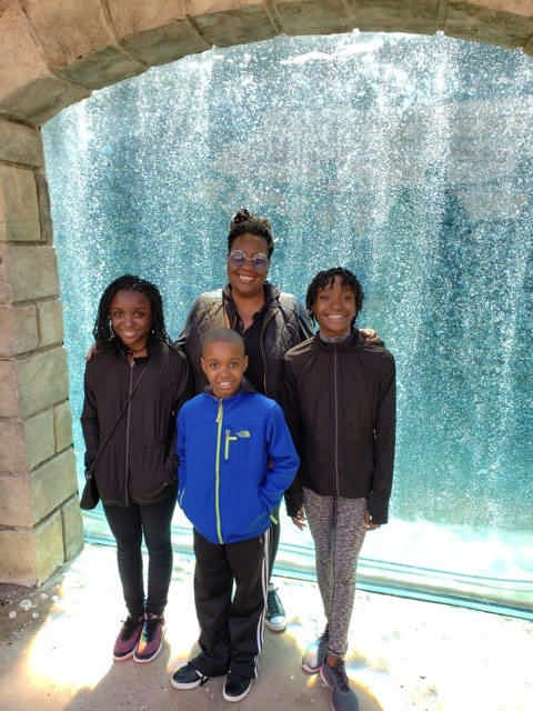 mom and children in front of water fountain enjoying a JAJF late stage cancer timeout 