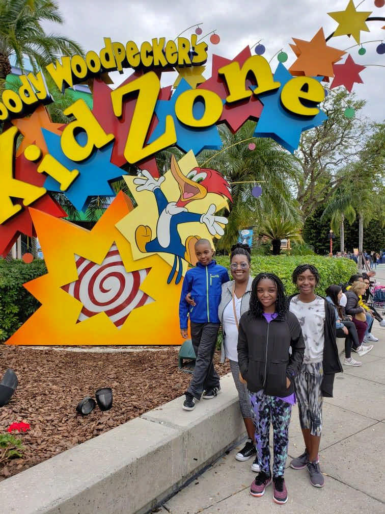 family at KidZone sign enjoying a JAJF late stage cancer timeout 