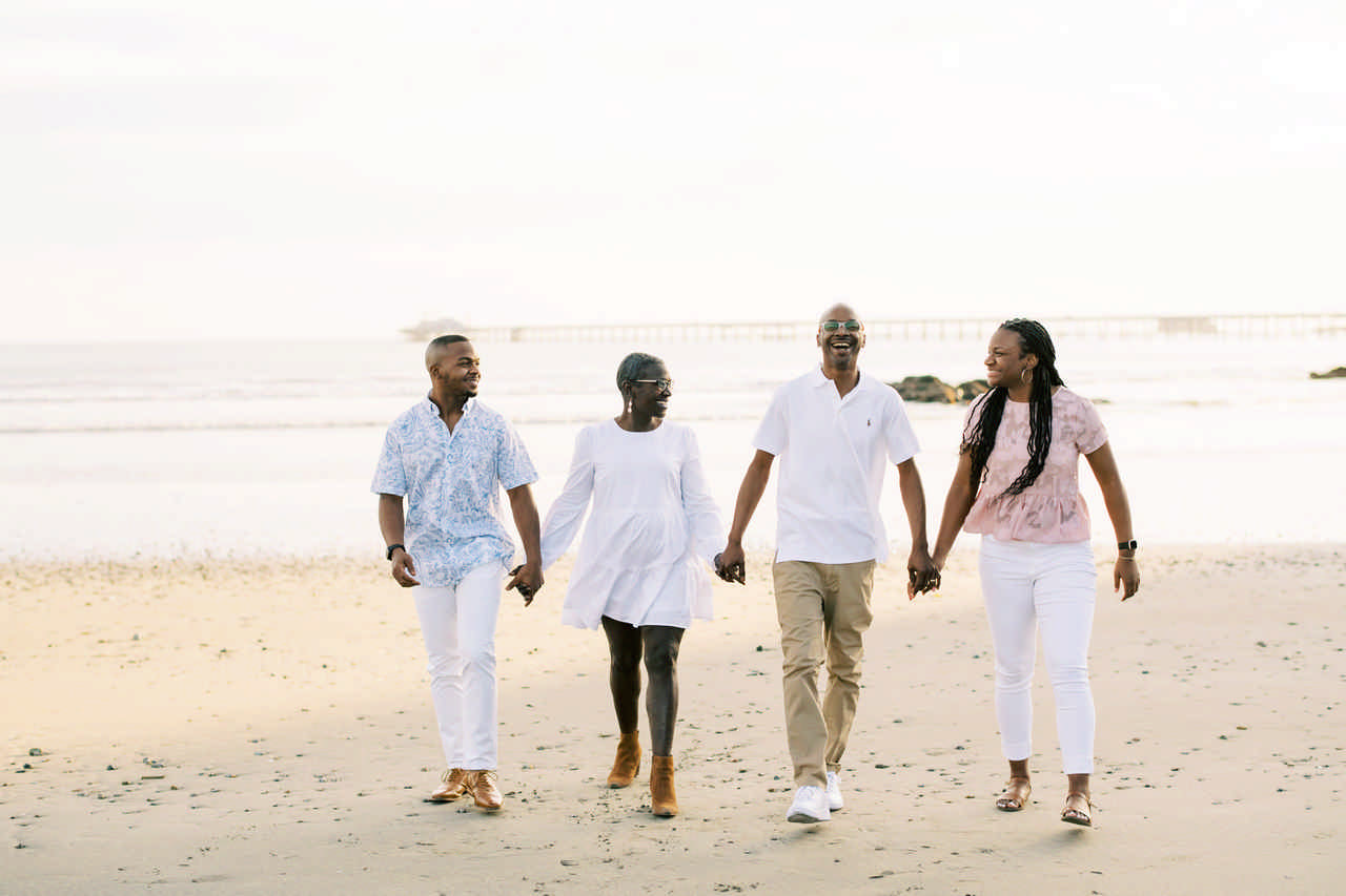 family walking hand in hand on the beach enjoying a JAJF late stage cancer timeout 