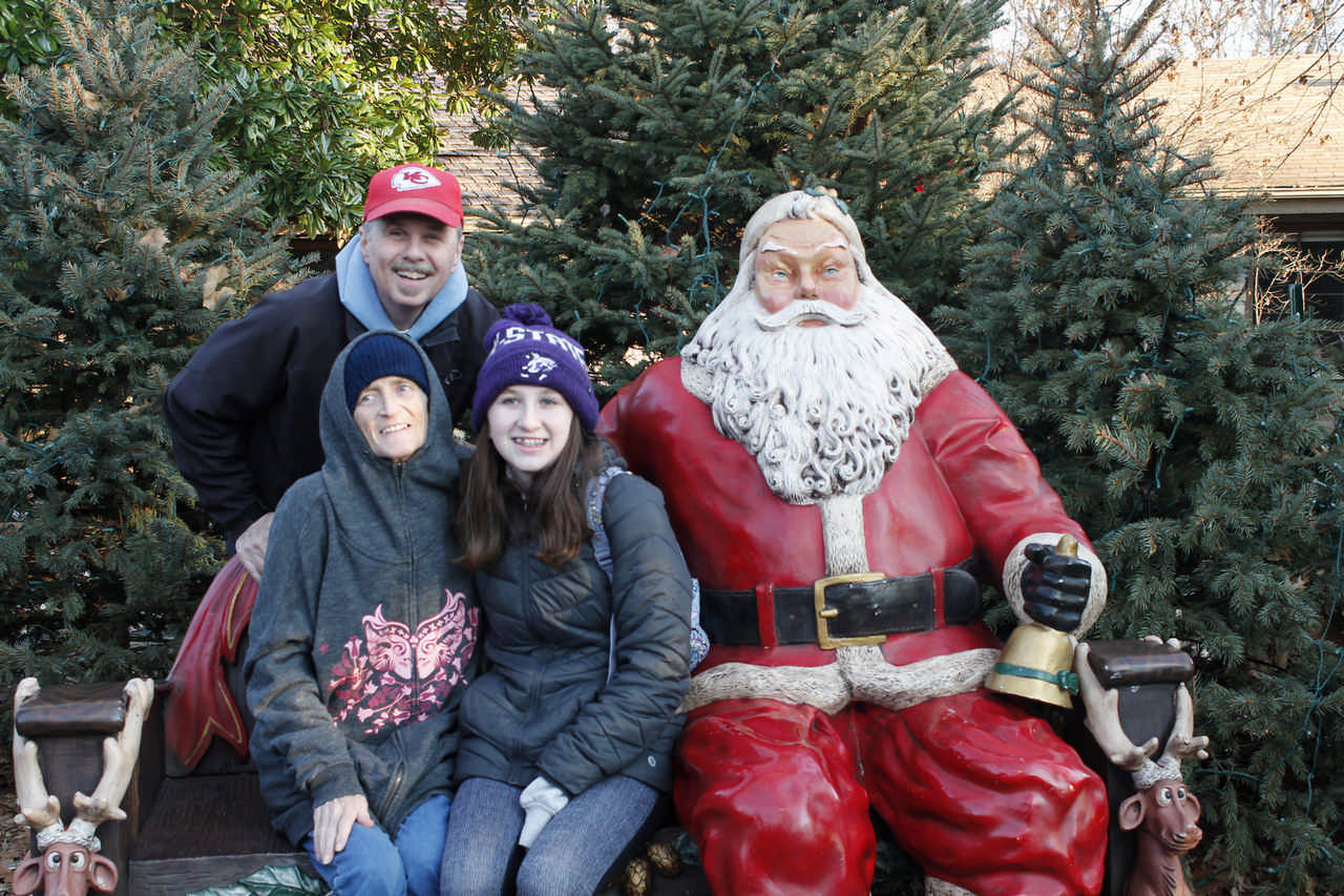 family posing with Santa statue enjoying a JAJF late stage cancer timeout 