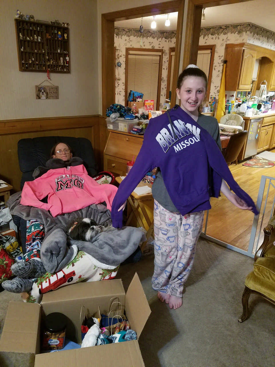 mom and daughter wearing Missouri sweatshirts enjoying gifts from JAJF 