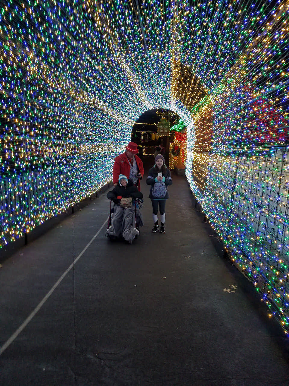 daughter and mom in Christmas tree light walkway enjoying a JAJF late stage cancer timeout 