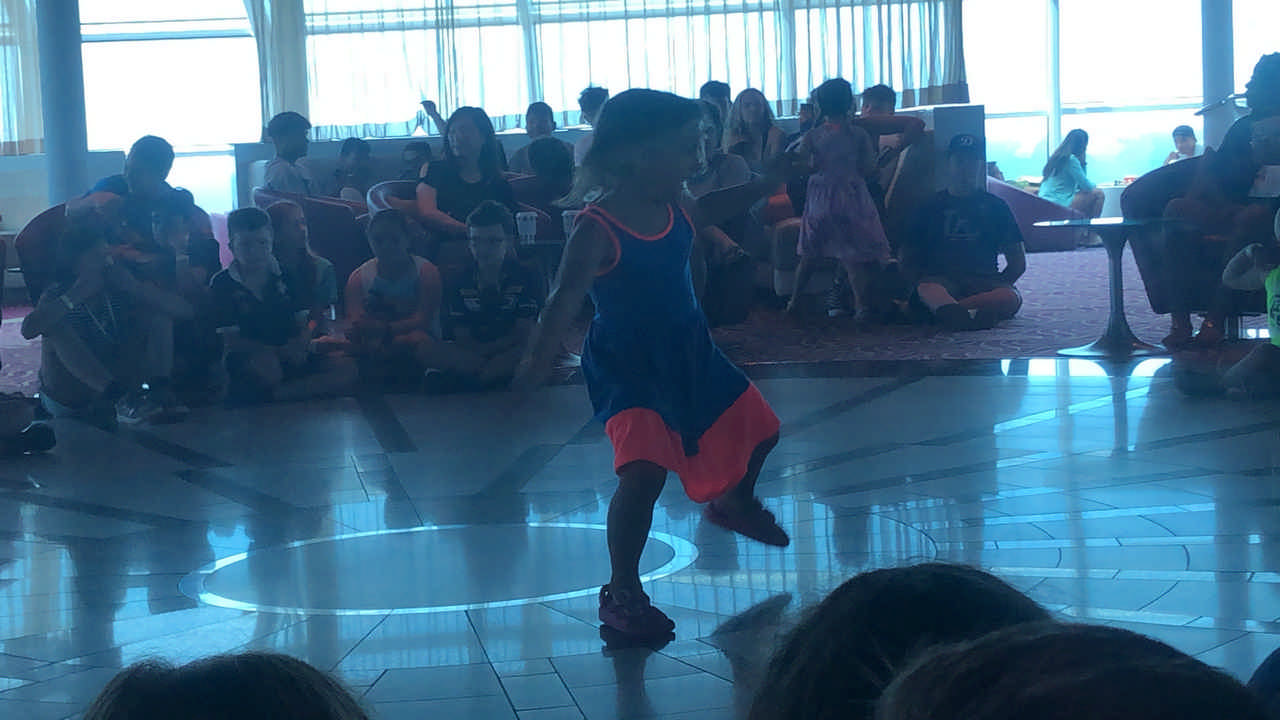 young girl dancing in a circle of people 
