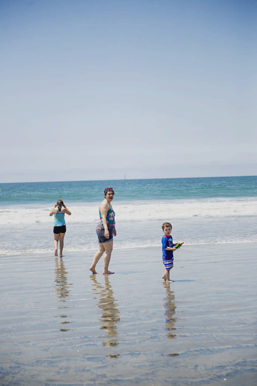 mom and children playing on the beach during a JAJF cancer timeout 