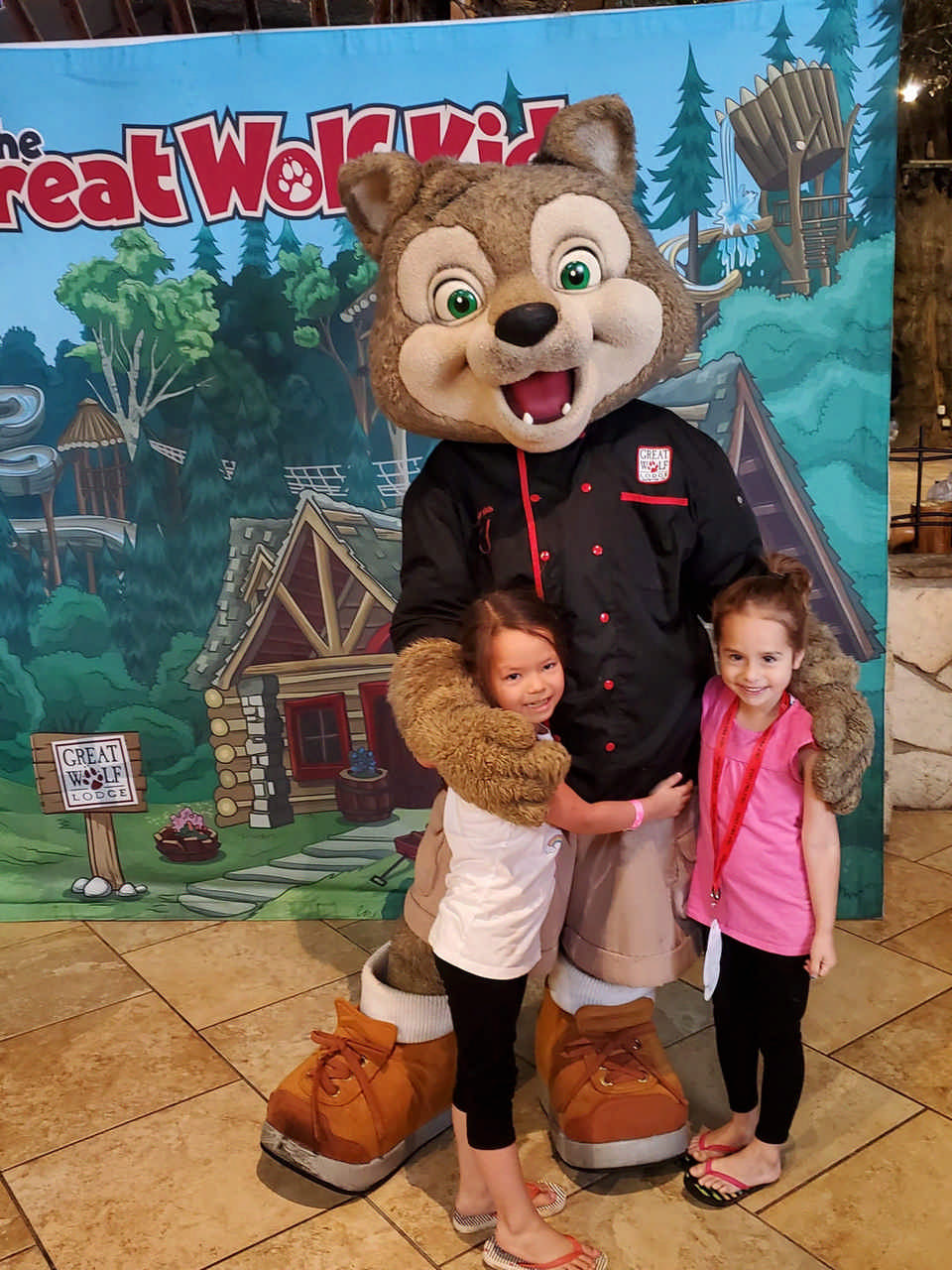 two young girls with Great Wolf Lodge character during a JAJF late stage cancer timeout 