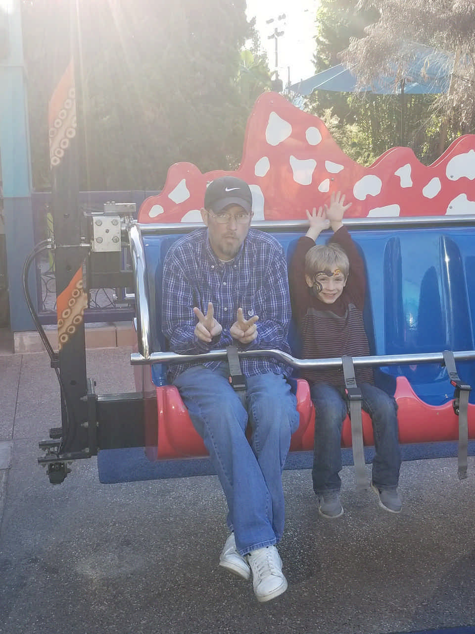 man and young boy on theme park ride enjoying a JAJF WOW experience 
