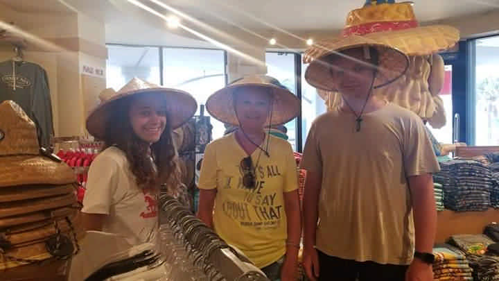 family wearing woven hats in surf shop on JAJF WOW experience 