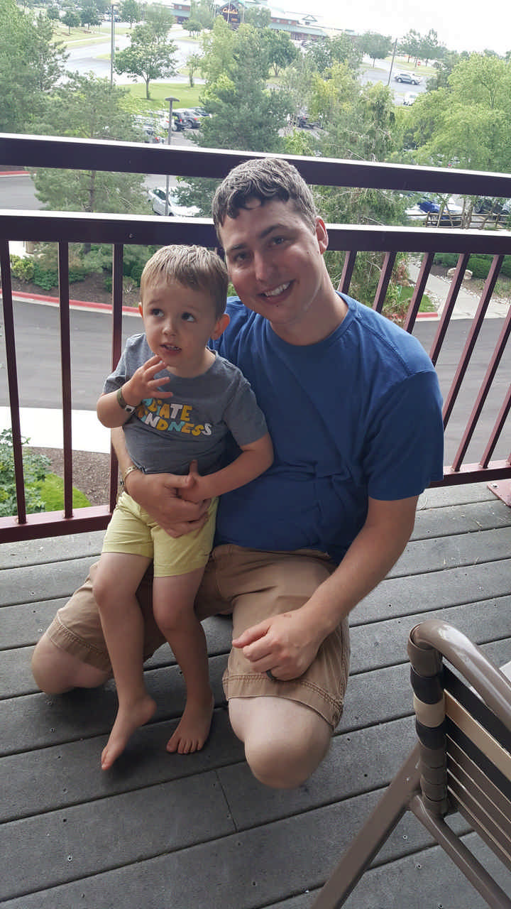 dad and toddler son on hotel balcony enjoying a Jack and Jill Foundation WOW experience 