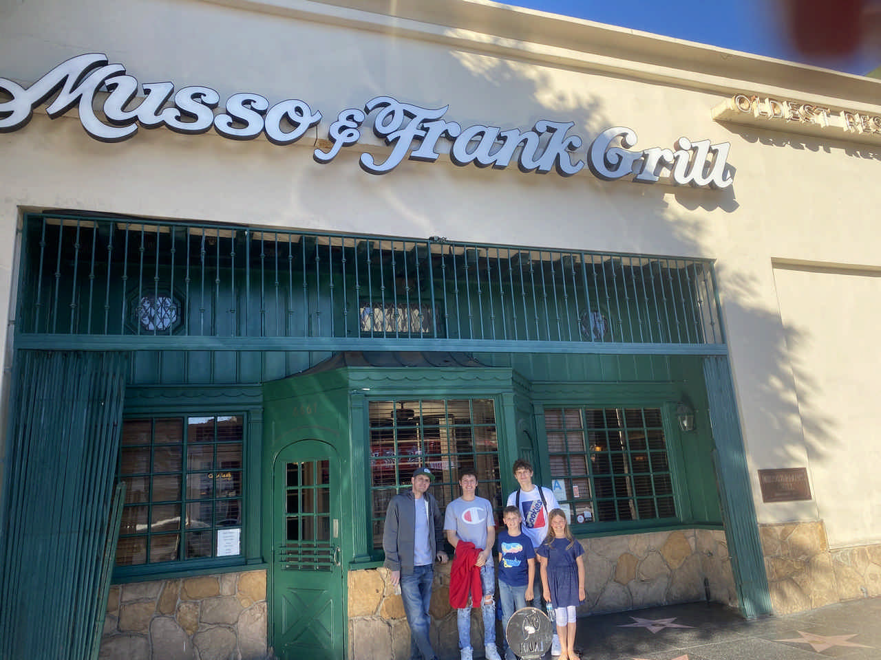 family outside Musso and Frank Grill restaurant on a JAJF WOW experience 