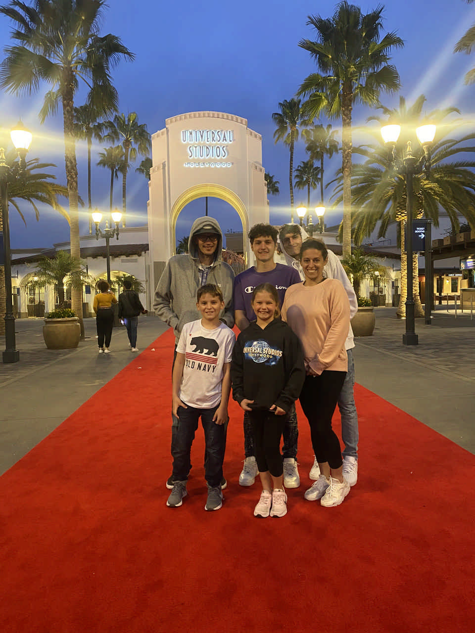 family outside entrance to Universal Studios during a JAJF WOW experience 