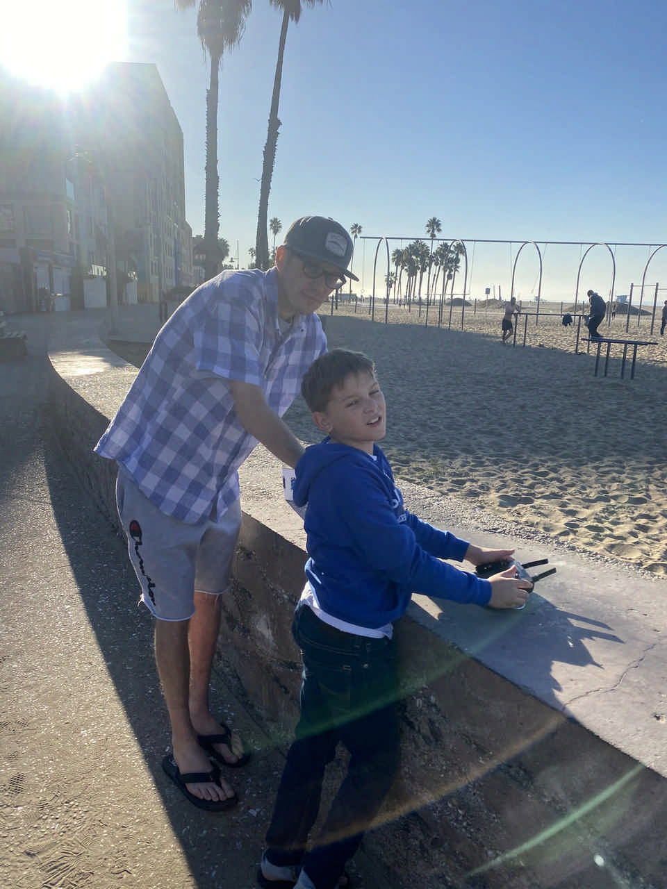 man and young boy at playground on the beach during a JAJF WOW experience 