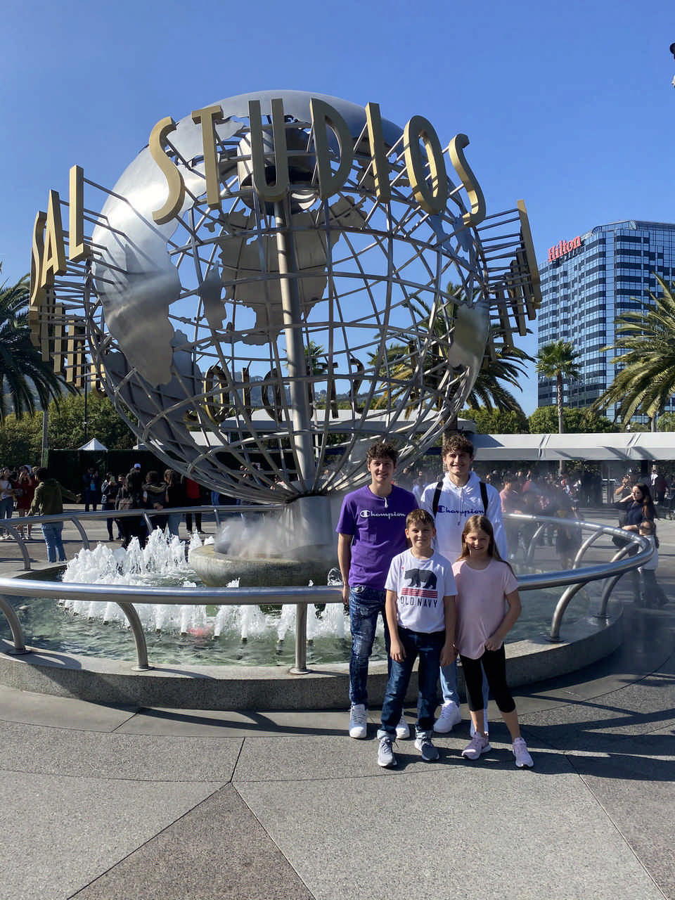 kids standing in front of Universal Studios globe during a JAJF WOW experience 